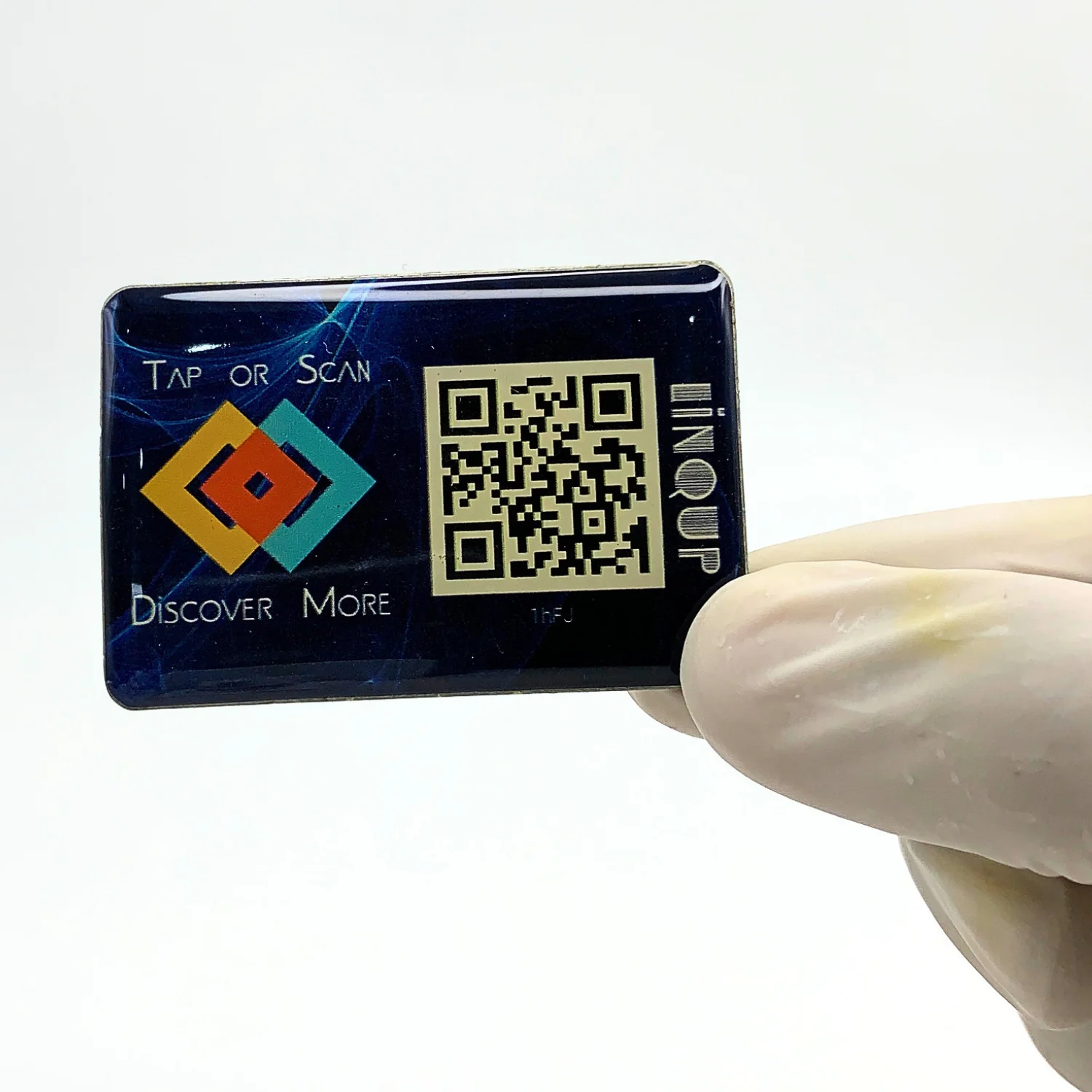LINQS smart NFC and QR dynamic sticker held by hand showing glossy epoxy dome finish